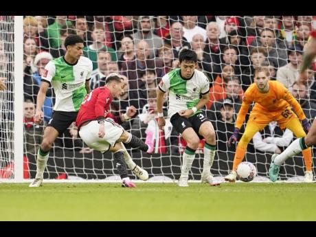 Manchester United’s Antony (second left) scores his side’s second goal during the FA Cup quarterfinal match between Manchester United and Liverpool at the Old Trafford stadium in Manchester, England, yesterday.