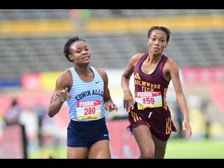 Monique Stewart (left) of Edwin Allen High takes gold in the Class Two 1500m  final ahead of Cindy Rose of Holmwood Technical at last year’s ISSA/GraceKennedy Boys and Girls’ Championships.