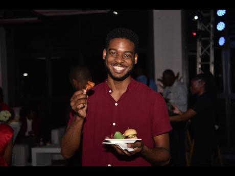 Food influencer, Joel Young Sang, showcases the sweet chilli chicken bites from his plate. 