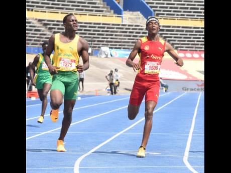 Wolmer's Boys School's Class 3 100-metre champion Mario Ross (right) wins heat two of the 200 metres at the ISSA/GraceKennedy Boys and Girls' Athletics Championships inside the National Stadium this morning. St Jago's Andre Boyd is second.