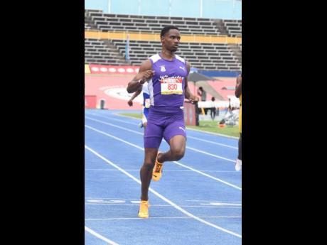 Kingston College's Amal Glasgow cruises during a boys' Class 1 200-metre heat at the ISSA/GraceKennedy Boys and Girls' Athletics Championships inside the National Stadium.