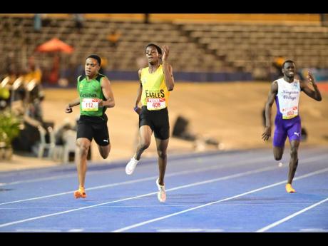 Excelsior High School's Demarco Bennett (centre) wins the boys' 400 metres at the ISSA/GraceKennedy Boys and Girls' Athletics Championships inside the National Stadium earlier this evening. Calabar's Nickecoy Bramwell (left) was second.


