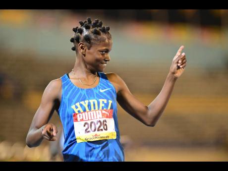 Hydel High School's Abigail Campbell points skyward after winning the girls' Class 1 400 metres at the ISSA/GraceKennedy Boys and Gils' Athletics Championships inside the National Stadium this evening.