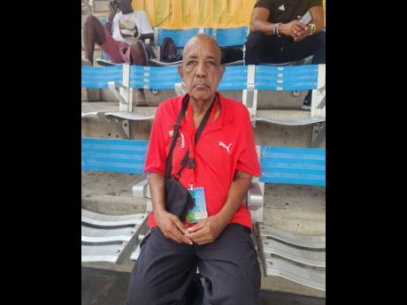 Veteran journalist Bobby Fray watching the action on yesterday’s third day of the 2024 ISSA-GraceKennedy Boys and Girls’ Athletics Championships at the National Stadium.