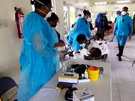 Disabled Haitian children receiving medical care from a team of Ministry of Health officials at the Ken Wright Pier in Port Antonio, Portland, after their arrival in the island yesterday.