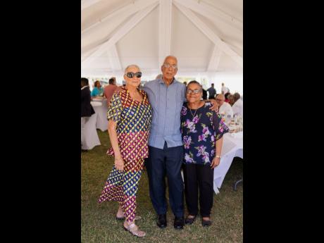 Retired HR manager Andrea Fletcher (left) stands with one of MFG’s former managing partners, Stephen Shelton, and his wife, Sharon.