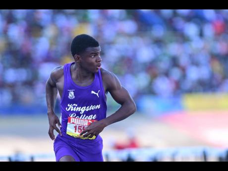 Kingston College’s Taj-Oneil Gordon looks across at his rivals to confirm his victory in the Class Two boys' 110 metres hurdles at the ISSA/GraceKennedy Boys and Girls' Athletics Championships at the National Stadium today. Gordon clocked 13.94 seconds t