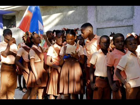Students from the private school Gabriel stand in line as they prepare to start their school day in Port-au-Prince, Haiti.