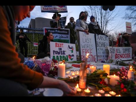 Demonstrators light candles during a vigil outside the Israeli Embassy, on February 26 in Washington. 