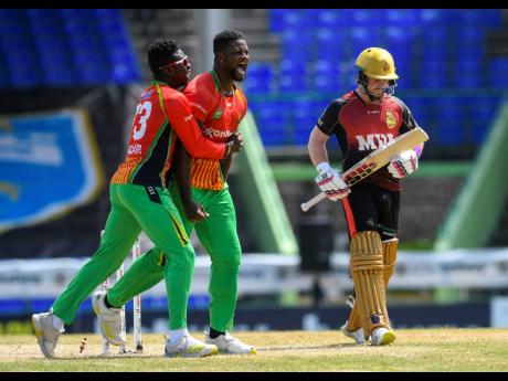 Romario Shepherd (centre) and Kevin Sinclair (left) of Guyana Amazon Warriors celebrate after defeating the Trinbago Knight Riders during a 2021 Hero Caribbean Premier League match at Warner Park Sporting Complex in Basseterre, St Kitts and Nevis.