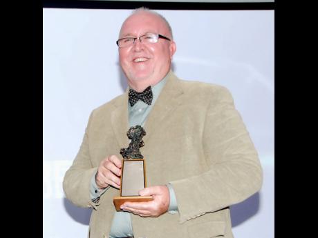 Brian Heap poses with his award for Best Drama for ‘Departure in the Dark’ at the 2014 Actor Boy Awards held at the Jamaica Pegasus Hotel in New Kingston.