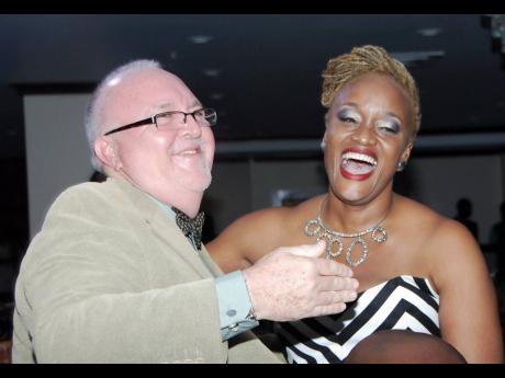  An elated Nadean Rawlins is congratulated for winning Best Actress in a Lead Role by Director Brian Heap at the 2014 Actor Boy Awards, New Kingston.
