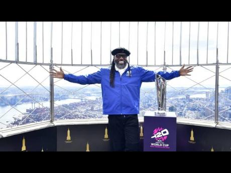 Chris Gayle displays the ICC Men’s T20 World Cup Trophy atop the Empire State Building in New York.