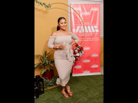 Danielle Lee-Grey of BH Beauty House is looking chic in this nude off-the-shoulder dress. 