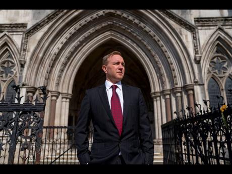 Financial market trader Tom Hayes, who was jailed alongside Carlo Palombo over interest rate benchmark manipulation, looks on outside the Royal Courts of Justice in London on Wednesday, March 27, 2024.