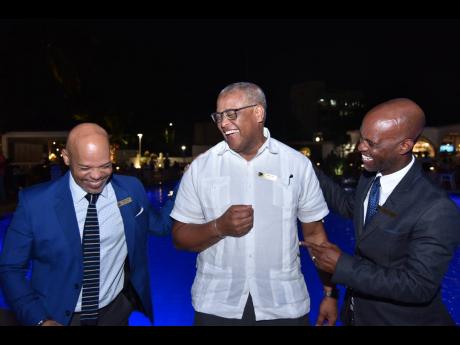 Mr. Brian Sang, General Manager of the Jamaica Pegasus Hotel (centre),  Mr. Maurice Bryan, Sales and Reservation’s Manager of the Jamaica Pegasus Hotel (left) and Alrick Sucki, Operations Manager at the Jamaica Pegasus Hotel (right) sharing a monent at t