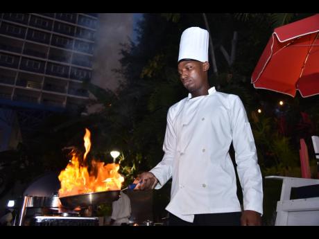 Chef Martienno Hylton serving up his signature Pepper Shrimp Flambée. 