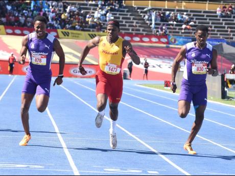 Kingston College’s Marcinho Rose (left), teammate Amal Glasgow (right), and Wolmer’s Boys’ School’s Gary Card as they go to the line together in the boys’ Class 1 200-metre final at the ISSA/GraceKennedy Boys and Girls’ Athletics Championships 