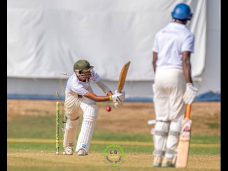 St Jago High School batsman Lindale Anderson has his stumps disturbed by the bowling of Excelsior High School’s Tamarie Redwood during their ISSA First Global Bank Grace Shield final at Sabina Park yesterday. Redwood would end with figures of 5-15.