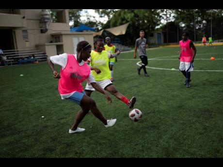 AP 
In this June 2023 photo, teenage girls are seen playing football at the Union School in Port-au-Prince, Haiti. 
