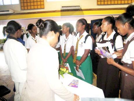 In this file photo, students are seen interacting with Students' Loan Bureau officers. The Gleaner editorial writes: The question of how Jamaica finances education generally, and tertiary education in particular, is an important one in the context of the i