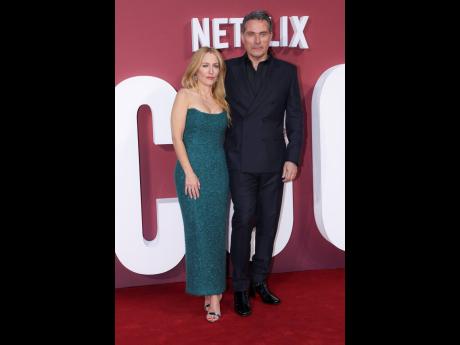 Gillian Anderson and Rufus Sewell pose for photographers upon arrival at the World premiere of the film ‘Scoop’ on March 27, in London. 