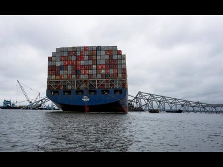 The Dali, a massive container ship from Singapore, still sits amid the wreckage and collapse of the Francis Scott Key Bridge in the Baltimore port, Monday, April 1, 2024.