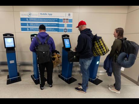 International travellers not using the Mobile Passport Control app, stop and use the portal to get their initial processing and instructions on their next procedure in the port of entry at Washington Dulles International Airport in Chantilly, Virginia, on 