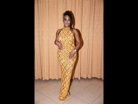 Taking a break from her books, Xodus Ambassador Danielle Rookwood stuns in this gold floor-length number. 