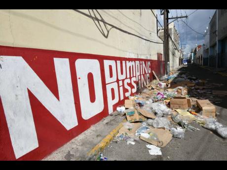 This file photo shows garbage strewn in Luke Lane, downtown Kingston.