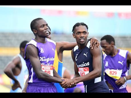 
Kingston College’s Brian Kiprop (left) is congratulated by Jamaica College’s Kemarrio Bygrave after he won the Class One Boys’ 1,500 metres at the ISSA/GraceKennedy Boys and Girls’ Athletics Championships at the National Stadium.