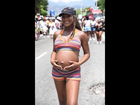 Miss Universe Jamaica 2023 finalist, Tika Rutherford, cradles her bump during the Carnival in Jamaica Road March. 
