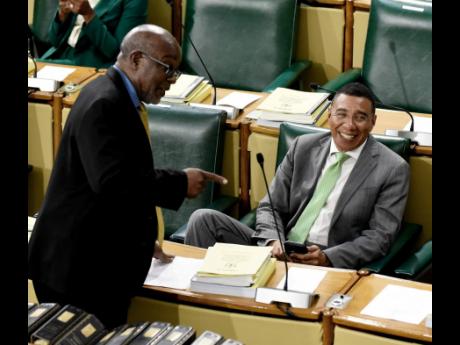 Fitz Jackson (left), member of parliament, St Catherine Southern, crossed the aisle to share a moment with Prime Minister Andrew Holness during the sitting of the Parliament.
