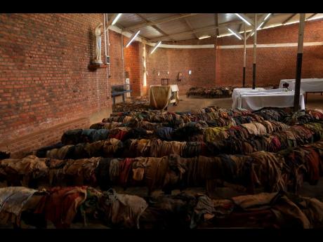 The clothes of Victims who were slaughtered as they sought refuge inside and around the Catholic church, cover the pews as a memorial to the thousands who were killed during the 1994 genocide, in Nyamata, Rwanda.