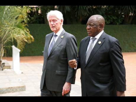 Former US President Bill Clinton (left) and South Africa’s President Cyril Ramaphosa arrive to lay a wreath at a ceremony to mark the 30th anniversary of the Rwandan genocide, held at the Kigali Genocide Memorial, in Kigali, Rwanda.