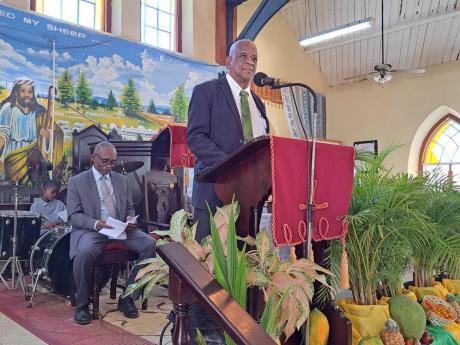 Franklin Witter, state minister in the Ministry of Agriculture, Fisheries and Mining, addresses the 41st annual National Farmers’ Month church service at the Kettering Baptist Church in Duncans, Trelawny, yesterday. Also pictured is Devon McAnuff, head d