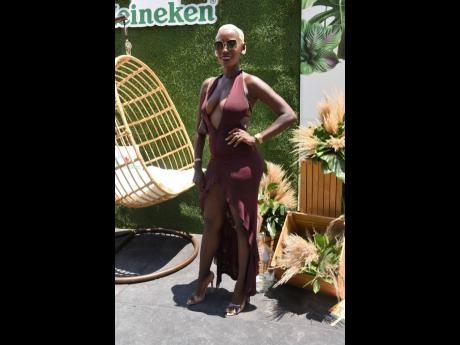 Ashley-Ann Stamps captivates in this chocolate-brown dress, commanding attention at the Heineken-sponsored Sunrise Breakfast Party.