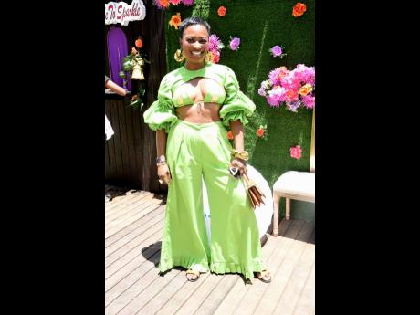 Kadisha King flaunts a lime green suit with puff sleeves, hand-picked for the occasion.