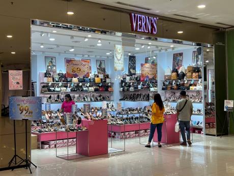 People shop at a Vern’s outlet at a shopping mall in Kuala Lumpur, Malaysia, Monday, April 8, 2024. Vern’s Holdings, a Malaysian shoe company has apologized and stopped selling some of its footwear after some Muslims said the logo resembled the Arabic 