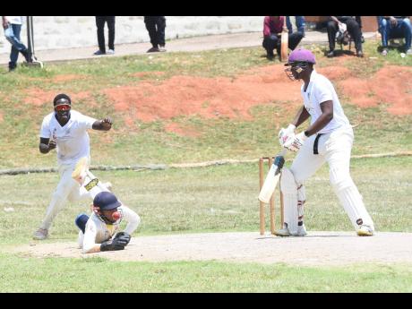 May Day High School wicketkeeper Javed Williams (centre) dives but could not take a catch to dismiss Manchester High School’s Rhevon Martin (right) during the ISSA GK Insurance Grace Headley Cup final. Also in the picture is May Day’s Reon Edwards.