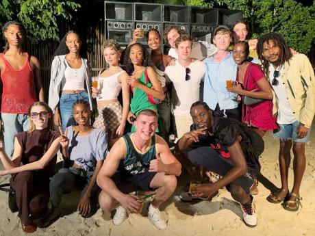Post-shoot at GoldenEye in St Mary, Burberry Chief Creative Officer Daniel Lee (middle row, fourth right) and the campaign’s  casting director Finlay Macaulay (third right) shared the frame with SAINT International models; actor and musician Sheldon Shep