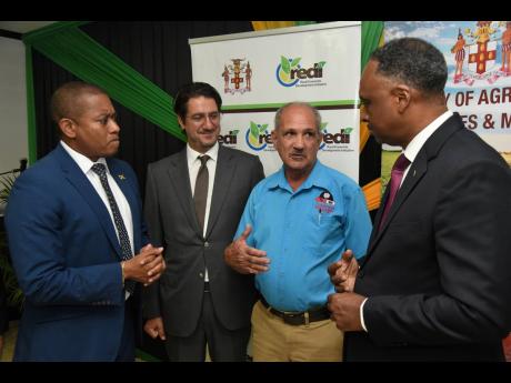 Courtney Harford (second right), director of Champion Industrial Equipment, assures (from left) Agriculture Minister Floyd Green; Emre Ozaltin, World Bank programme leader; and Jamaica Social Investment Fund Managing Director Omar Sweeney that the Agro-Inv