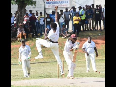 Manchester High’s Rasheed Harriott (second left) celebrates after he bowled May Day High’s Devar Murray (second right) on Wednesday’s opening day of the ISSA GK Insurance Grace Headley Cup final at Manchester High.  Looking on are Pajay Nelson (left)