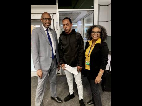 Jamaica’s Consul General Kurt Davis (left) and Althea Riley (right) acting chief liaison officer in Toronto, have a special welcome for Valwalda Morrison, a first-timer to the Seasonal Agriculture Workers Programme.  