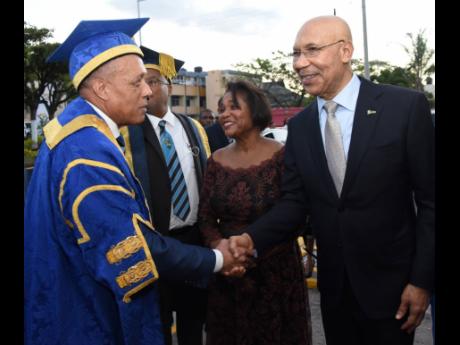 Aldrick McNab (left) is congratulated by Governor General Sir Patrick Allen shortly after he was installed as the fifth pro-chancellor of The University of Technology, Jamaica (UTech), on Thursday. Looking on are Lady Allen (second right) and Ambassador Ll