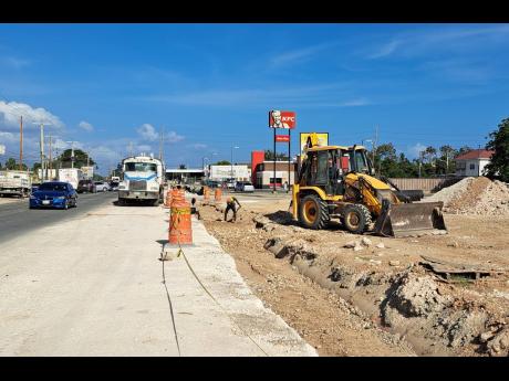 Expansion works under way along Grange Lane in Portmore, St Catherine, on Friday.