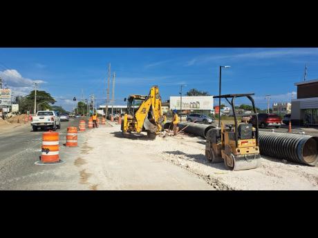 Expansion works under way along Grange Lane in Portmore, St Catherine, on Friday.