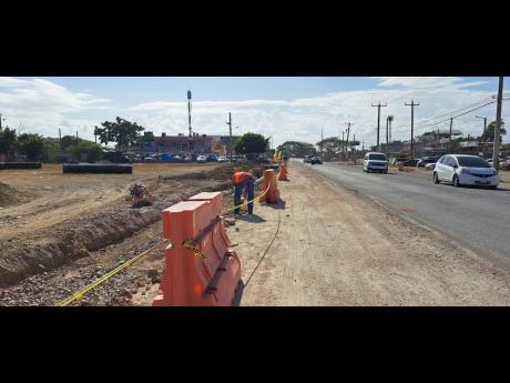 Expansion works under way along Grange Lane in Portmore, St Catherine, on Friday.