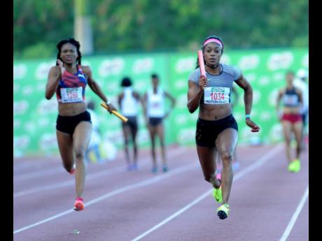 Elaine Thompson (right) runs the final leg for winners MVP Track Club  in the women’s 4x100 metres event at the Milo Western Relays held at the Montego Bay Sports Complex on Saturday, February 11, 2017.