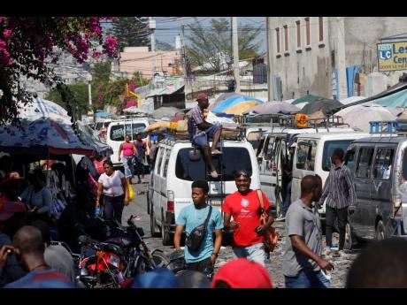 Pedestrians and commuters fill a street in Port-au-Prince, Haiti.